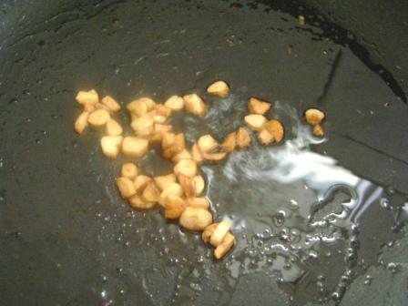 Heat oil in a pan. Add Garlic cloves and roast until they turn golden brown.